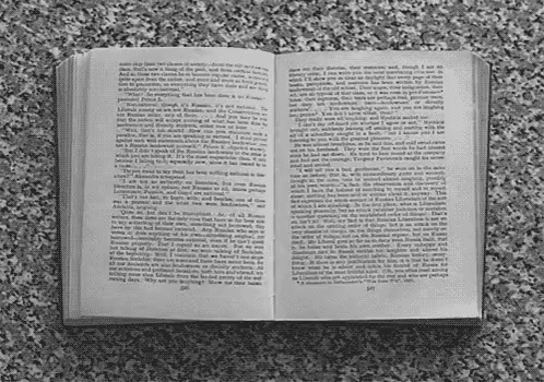 A Book Is Open To A Page That Says " I Am " GIF