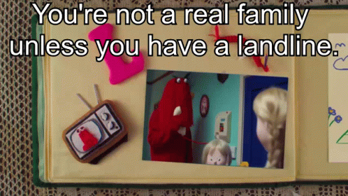 A Book Is Open To A Page That Says You 'Re Not A Real Family Unless You Have A Landline .. GIF