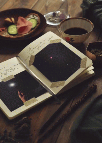 A Book Is Open To A Page With A Fireworks Display GIF