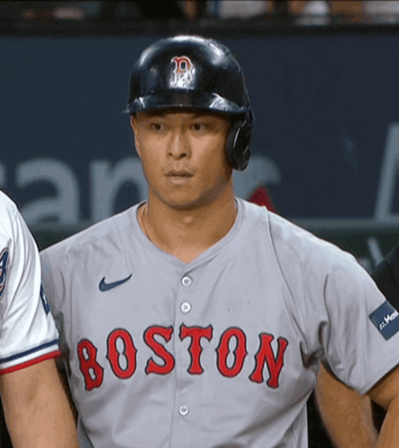 A Boston Baseball Player Wearing A Helmet And A Grey Jersey GIF
