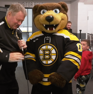 A Boston Bruins Mascot Is Being Interviewed By A Reporter GIF