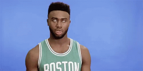 A Boston Celtics Basketball Player Is Making A Funny Face While Wearing A Green Jersey . GIF