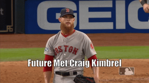 A Boston Red Sox Baseball Player Stands On The Field In Front Of A Geico Banner GIF