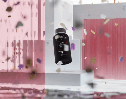 A Bottle Of Anti-Delusion Pills Is Floating In The Air Surrounded By Confetti GIF