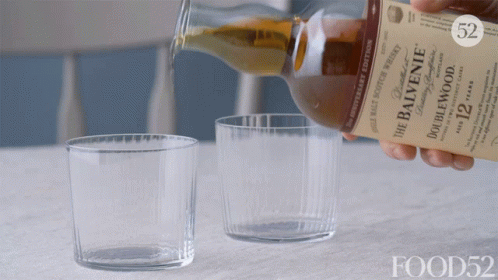 A Bottle Of Balvenie Whiskey Is Being Poured Into A Glass GIF