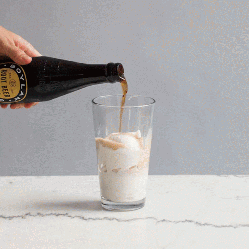 A Bottle Of Boot Beer Is Poured Into A Glass GIF