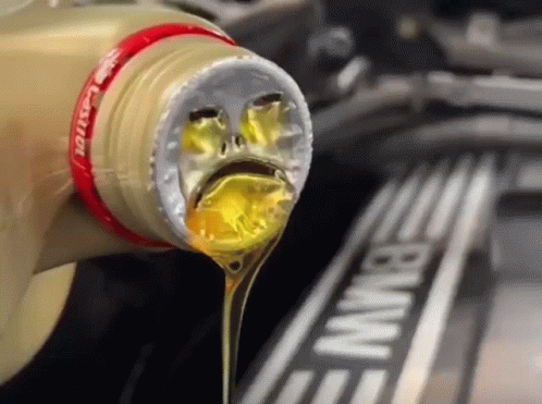 A Bottle Of Castrol Oil Being Poured Into A Bmw Engine GIF