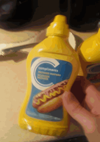 A Bottle Of Compliments Mustard Has A Picture Of A Hot Dog On It GIF