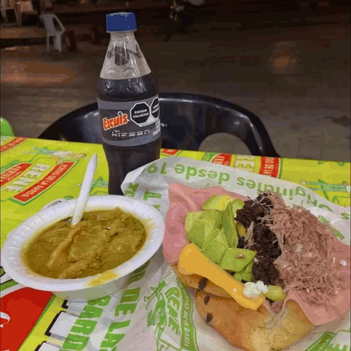 A Bottle Of Excels Sits Next To A Plate Of Food GIF