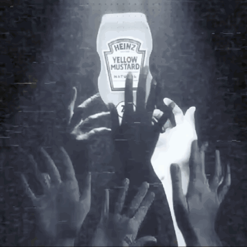a bottle of heinz yellow mustard is being held by a crowd of hands