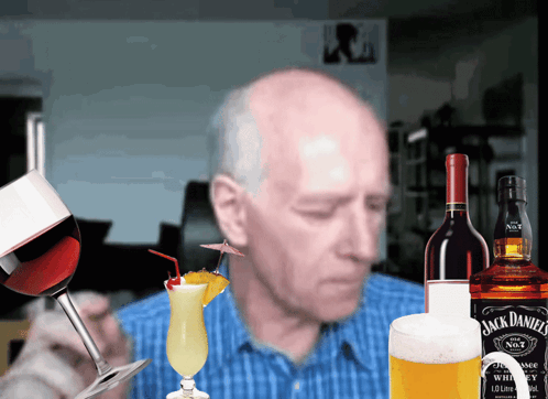 A Bottle Of Jack Daniel 'S Whiskey Sits Next To A Bottle Of Wine GIF