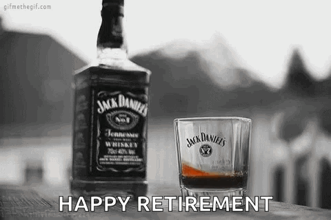 A Bottle Of Jack Daniels Whiskey And A Glass Of Whiskey On A Wooden Table . GIF
