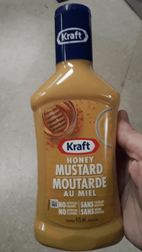 A Bottle Of Kraft Honey Mustard Is Being Held In Someone 'S Hand GIF