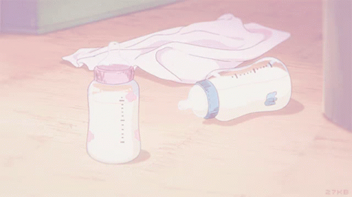 A Bottle Of Milk Sits On A Wooden Floor Next To A Towel GIF