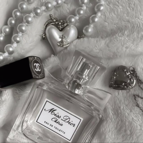 A Bottle Of Miss Dior Cherie Eau De Toilette Surrounded By Pearls GIF