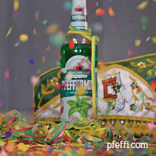 A Bottle Of Nordbrand Peppermint Is Surrounded By Confetti And Streamers GIF