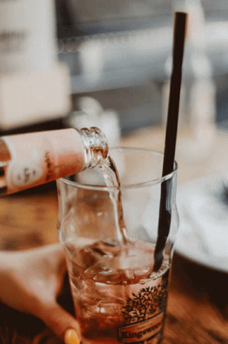 Wine Bottle Poured Into Glass With Straw GIF