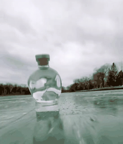 A Bottle With A Cork Is In The Water GIF
