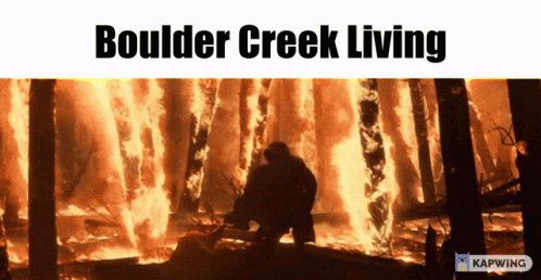 a boulder creek living poster with a man standing in front of a burning forest