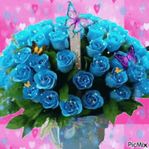 A Bouquet Of Blue Roses In A Vase With Butterflies On A Pink Background . GIF