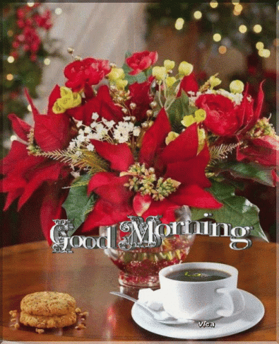 A Bouquet Of Red Flowers Sits On A Table Next To A Cup Of Coffee And A Plate Of Cookies GIF