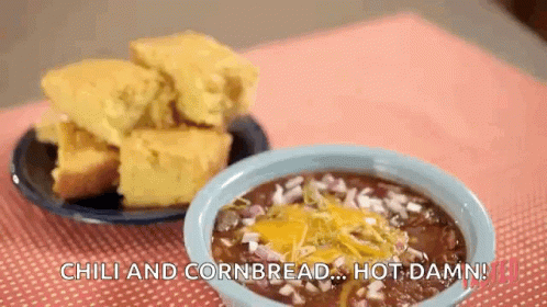 A Bowl Of Chili And Cornbread On A Table Next To A Bowl Of Chili And Cornbread . GIF