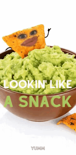 A Bowl Of Guacamole With A Tortilla Chip With A Face Painted On It GIF