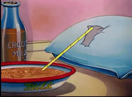 A Bowl Of Milk Sits On A Table Next To A Bottle Of Choco Milk GIF