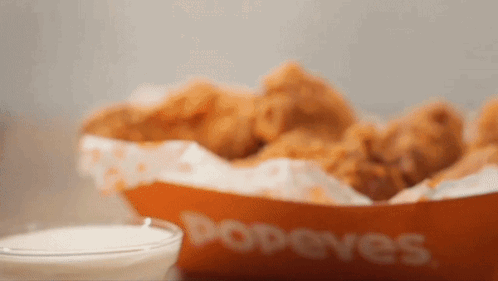 A Bowl Of Popeye 'S Fried Chicken And A Bowl Of Dipping Sauce GIF
