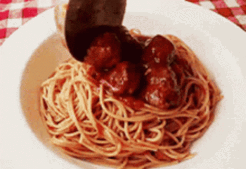 A Bowl Of Spaghetti And Meatballs With A Spoon In It GIF