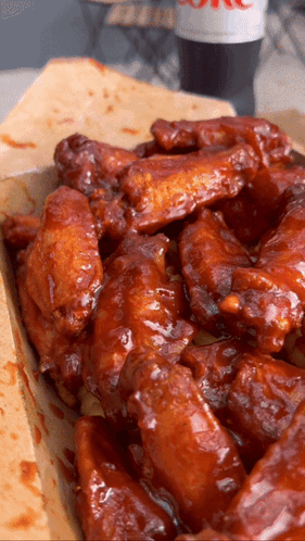 A Box Of Chicken Wings With A Coke On The Table GIF