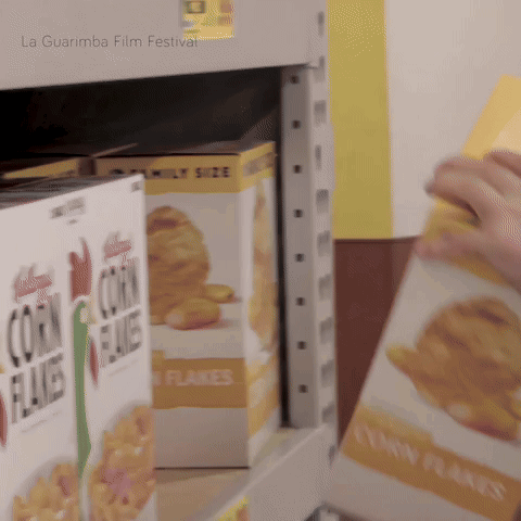A Box Of Corn Flakes Sits On A Shelf At A La Guarimba Film Festival GIF