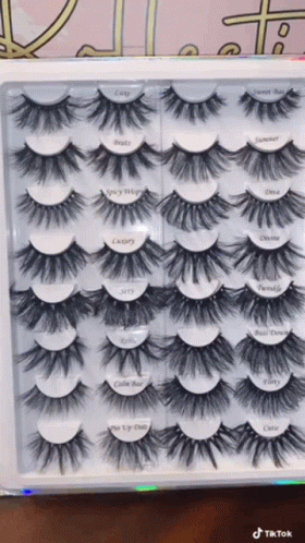 A Box Of Fake Eyelashes With Labels On Them Including One That Says ' Cutie ' GIF