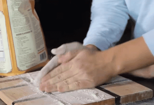 A Box Of Flour Sits On A Cutting Board GIF