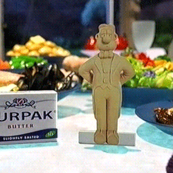 A Box Of Jrpak Butter Sits On A Table Next To A Figurine GIF