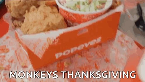 A Box Of Popeye 'S Fried Chicken Is On A Table GIF
