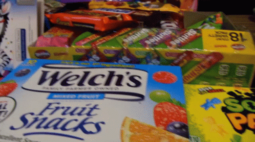 a box of welch 's fruit snacks sits next to other boxes of candy