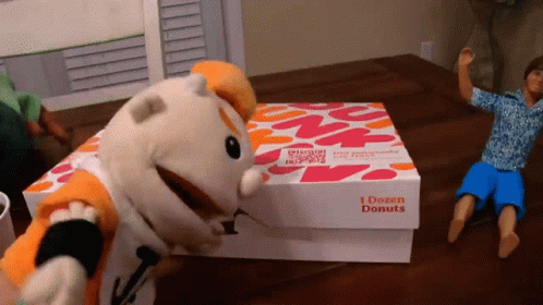A Box That Says 1 Dozen Donuts Sits On A Table GIF