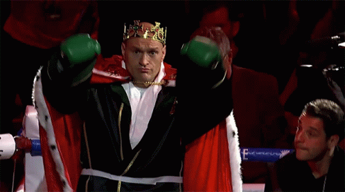 A Boxer Wearing A Crown And Green Boxing Gloves GIF