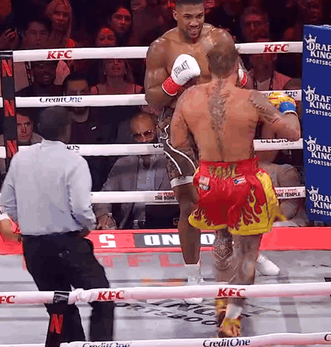 A Boxer Wearing Everlast Gloves Is Standing In A Boxing Ring GIF