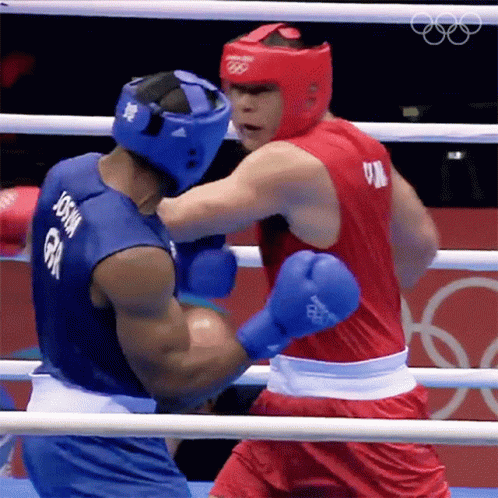 A Boxer With The Name Joshua On His Back Is Fighting Another Boxer GIF