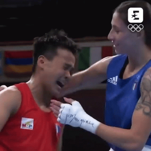 A Boxing Match Between A Man And A Woman With A Logo For The Olympics GIF