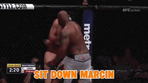 A Boxing Match Between Lewis And Tybura With The Words Sit Down Marcin On The Bottom GIF