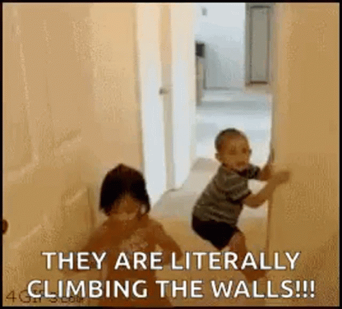 A Boy And A Girl Are Climbing The Walls In A Room . GIF