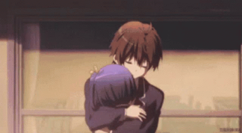 A Boy And A Girl Are Hugging Each Other In A Room . GIF