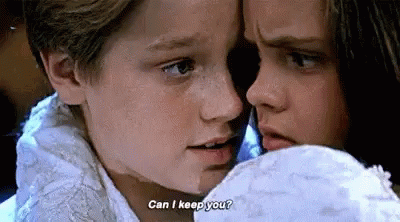 A Boy And A Girl Are Looking At Each Other And The Boy Is Asking The Girl If She Can Keep Him . GIF