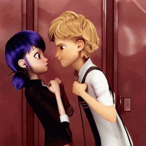 A Boy And A Girl Are Looking At Each Other In Front Of Red Lockers GIF
