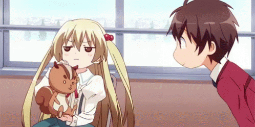 A Boy And A Girl Are Looking At Each Other While The Girl Is Holding A Stuffed Squirrel . GIF