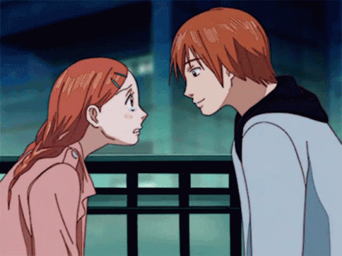 a boy and a girl are looking at each other with their eyes closed