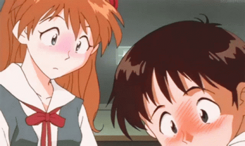 Boy And Girl Looking At Each Other With Closed Mouths GIF